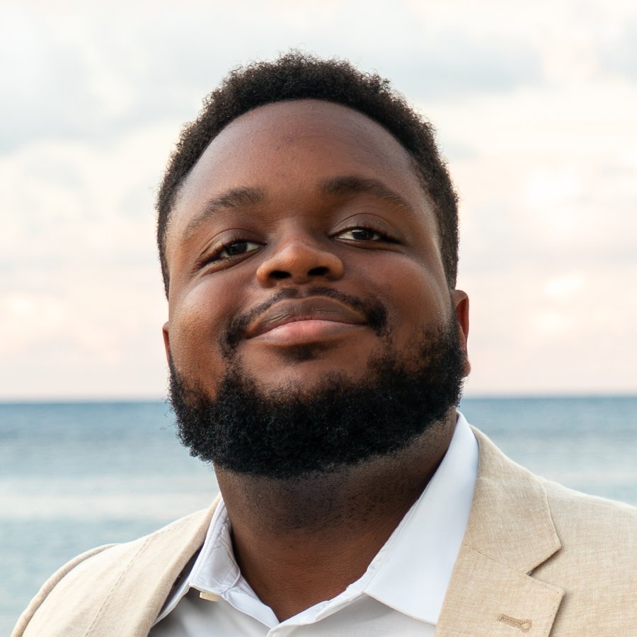 Sage smiling, with the ocean behind him